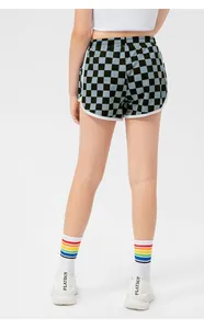 Rear view of girls' checkerboard sports shorts with white trim and elastic waist