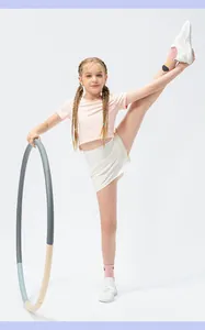 Detail of girls' breathable pink sports top and white quick-dry shorts for flexibility