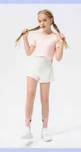 Detail view of girls' breathable pink crop top and white loose sports shorts set