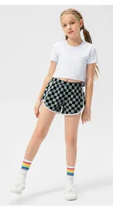 Close-up of girls checkerboard sports shorts with soft cotton white crop top