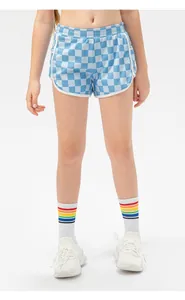 Detail of blue checkerboard girls' sports shorts with elastic waist and white piping
