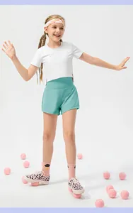 Girls' mint green high-waisted sports shorts and white cropped t-shirt set for tennis