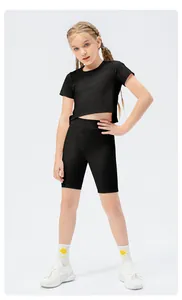 Detail view of high-elastic black girls' crop top and biker shorts for dance and sports