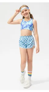Full view of girls athletic outfit with tie-dye tank top and checkered sports shorts