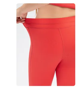 Detail showing the high elasticity and seamless waist of girls red yoga leggings