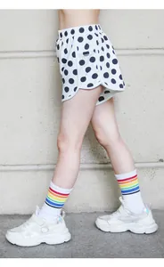 Macro shot of girls polka dot sports shorts with skin-friendly nylon and rainbow socks