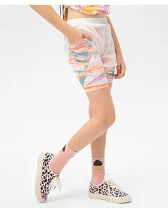 Detail view of girls' white layered sports shorts with vibrant geometric floral print liner