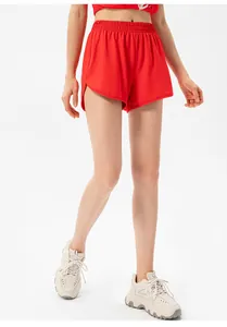 Close-up of women's red quick-dry running shorts with high elastic waist and side slits