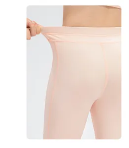 Close-up of high-elasticity waistband on girls' pink yoga leggings with flatlock seams