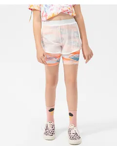 Detail of girls' 2-in-1 sports shorts with vibrant geometric print and outer mesh layer