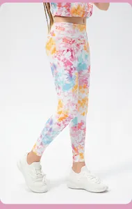 Detail of girls high-waisted fitness leggings with vibrant multi-color tie-dye print