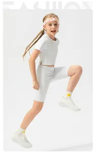 Detail of girls' white athletic set with short sleeve crop top and fitted cycling shorts