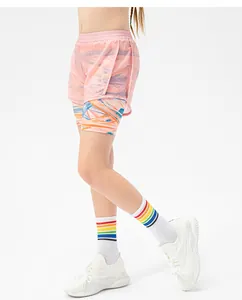 Detail of girls' 2-in-1 pink sports shorts with elastic waist and printed inner liner