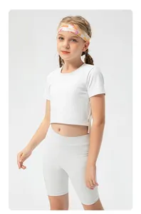 Detail showing elastic white cropped tee and high-waist shorts for girls' sports set