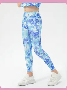 Detail of high-waist blue tie-dye leggings and crop top fitness set for girls