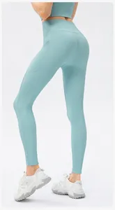 Close-up of light blue ribbed yoga pants featuring high waist and side pockets