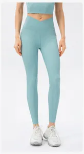 Detail of high-waisted blue yoga pants with crossover waist and ribbed texture