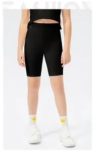 Detail of girls high-waisted black athletic bike shorts with elastic fabric for dance