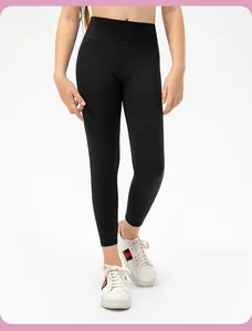 Detail of high-waist girls' athletic leggings showing stretchy black fabric and fit