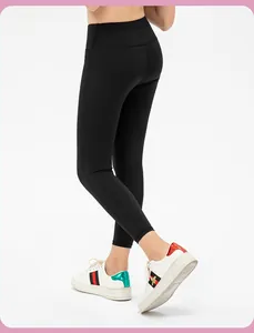 Close-up of black high-waisted girls' leggings showing matte fabric and body-hugging fit