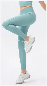 Detail of high waisted yoga leggings featuring V-cross waistband and side utility pockets