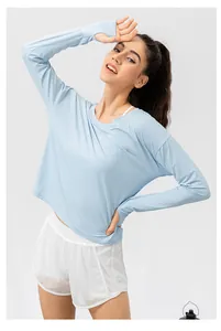 Detail of light blue sun-protection top with thumbholes and white elastic shorts