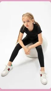 Detail of girls' black athletic leggings and high-elasticity slim fit sports t-shirt