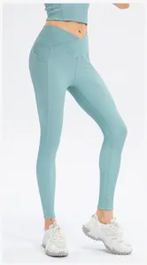 Close-up of high-waisted yoga pants with crossover waist and side functional pockets