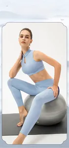 Light blue vintage yoga set with mandarin collar top and high waist leggings on yoga ball