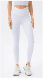 Detail of high waisted white ribbed yoga leggings featuring a stylish cross waist design
