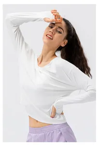 Detail of white long sleeve UV shirt with thumbholes and purple athletic shorts