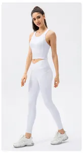 Detail of high waist white yoga leggings with side pockets and crisscross waistband