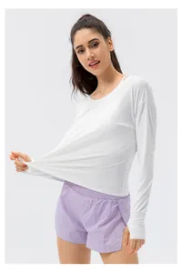 Stretch test of a white long-sleeve sun protection top and purple athletic shorts