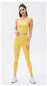 Macro detail of ribbed yellow yoga pants featuring a slimming crisscross V-shape waistband