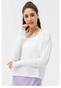 Detail of white long sleeve sun protection top featuring functional thumbhole cuffs