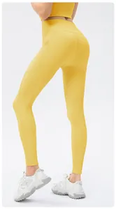 Detail view of the ribbed knit fabric and side pocket on high-waist yellow yoga pants