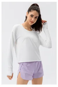 Detail of white long sleeve sun protection top with thumbholes and lilac sports shorts