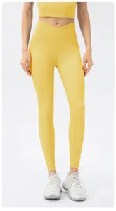 Detail of high-waisted ginger yoga pants with V-cross waistband and side pockets