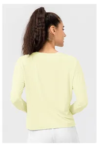 Detail of light yellow loose long-sleeve sun protection shirt with drop-shoulder seams