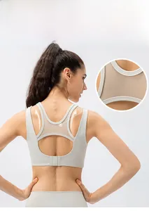 Detail view of breathable mesh stitching on back of off-white athletic sports yoga bra