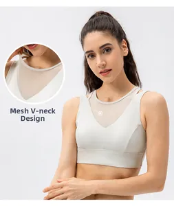 Close-up of mesh V-neck detail and breathable fabric on beige sports bra