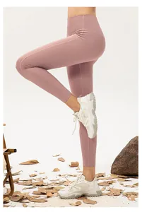 Detail of dusty pink high-waisted yoga leggings showing seamless stretch fabric and fit