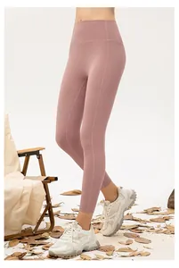 Close-up of high-waist yoga leggings in dusty pink with sculpting seams and slimming fit
