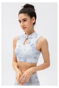 Close-up of traditional Chinese frog button and teardrop cutout on floral yoga crop top