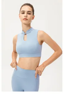 Close-up of light blue yoga set with traditional frog buttons and teardrop cutout detail