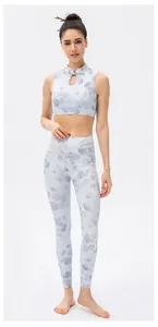 Detail of high-neck yoga top featuring teardrop cutout and traditional Chinese knot button