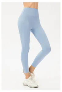 Detail of light blue high-waisted seamless yoga leggings with tight fit for fitness