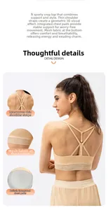 Detail view of apricot yoga bra featuring mesh splicing and criss-cross back straps