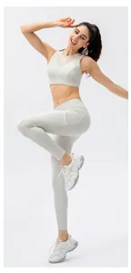 Detail view of breathable mesh neckline on the sports bra and practical side leg pockets