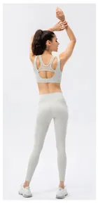 Detail of grey sports bra featuring breathable mesh patchwork and back buckle closure